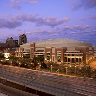 A large stadium-type building near a highway.